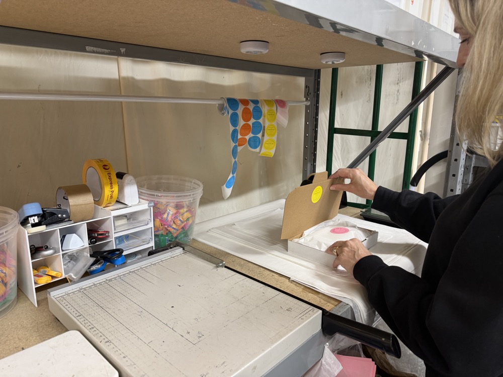 A member of the Sterling & Currency team preparing and sealing a parcel for dispatch